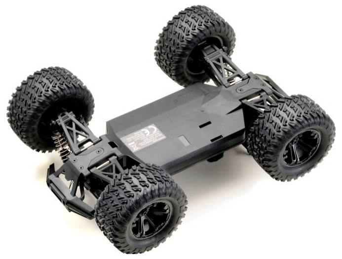 A black remote-controlled car chassis with large treaded wheels and visible suspension system, shown from a top-side angle.