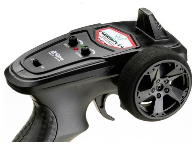 Remote control for an RC vehicle. Black casing, rotary knob and control lever. Brand logo and switches on the surface.