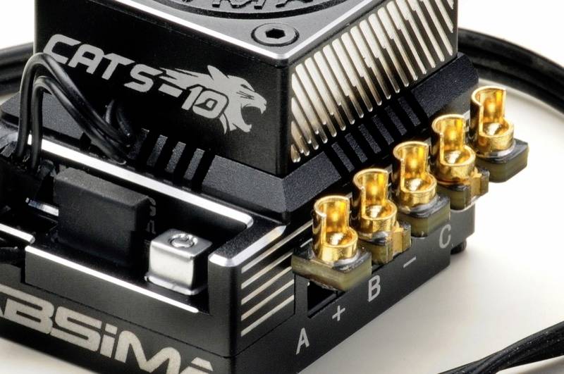 Black electronic component with golden connectors, cable connection, and the inscription 'CATS 10' and 'A+B=C'.