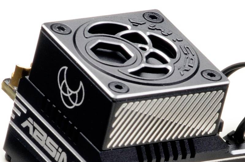 A radio-controlled model engine with a fan cover, featuring a stylised logo. The engine is black with silvery stripes and the brand name.