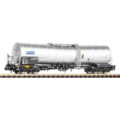 A silver goods wagon with the inscription 'GATX' is standing on a railway track. The wagon is a cylindrical tank car.