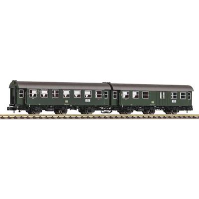 Two green railway carriages on tracks, side view, with multiple windows and labels on the doors.