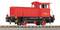 A red locomotive on railway tracks, side view. It bears the number '312 113-4'.