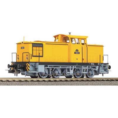 Yellow toy model of a locomotive on a section of railway track. The locomotive has distinctive black stripes and detailed wheel mountings.