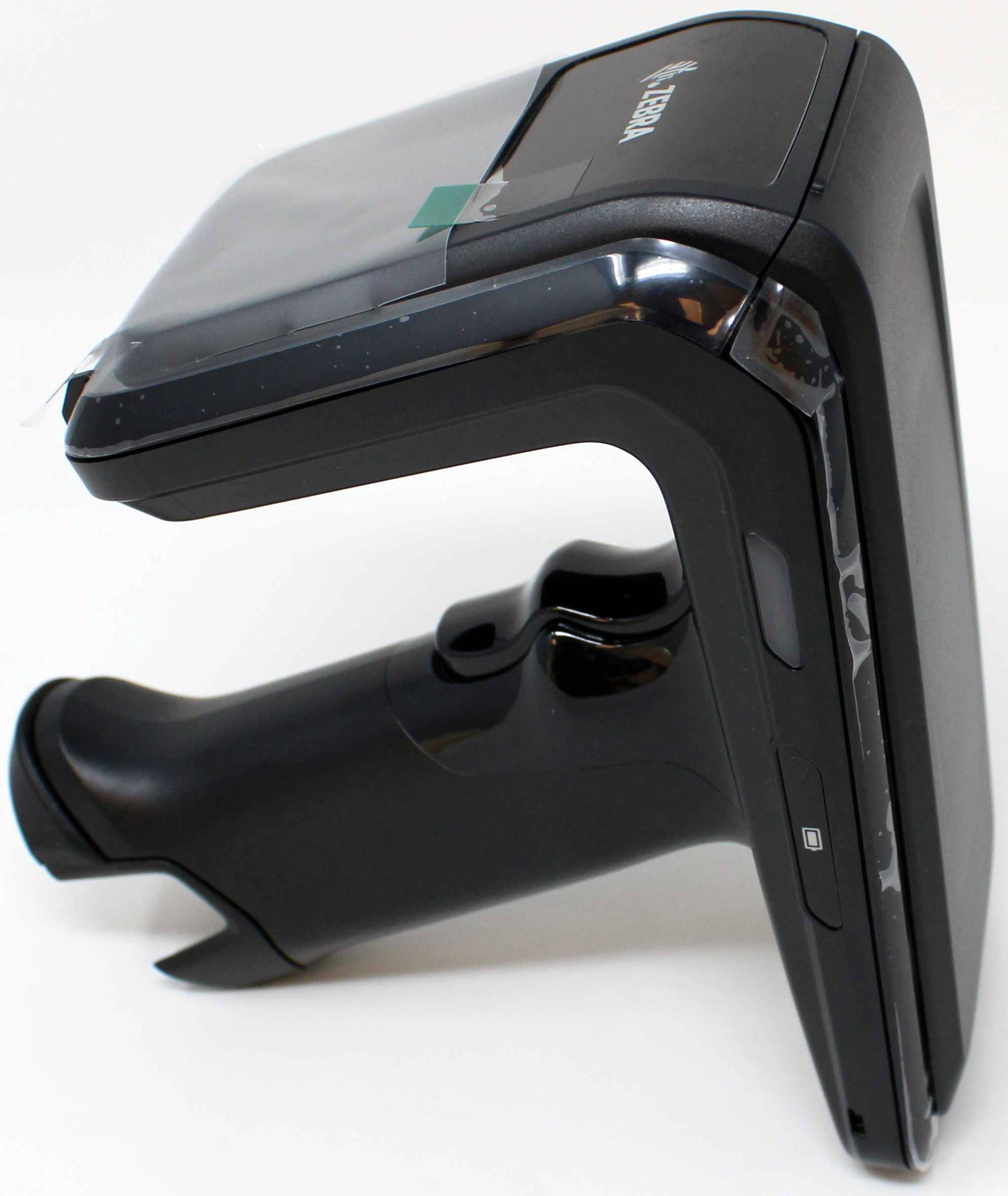 Hand-held scanner viewed from the side, predominantly black, with an ergonomic grip and rounded scanning area at the top.