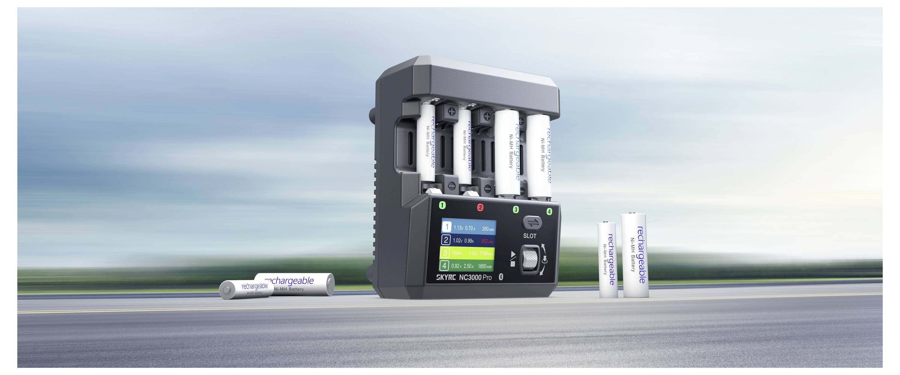 A battery charger with four AA batteries inserted, featuring a digital screen and buttons. Four additional batteries stand beside it.