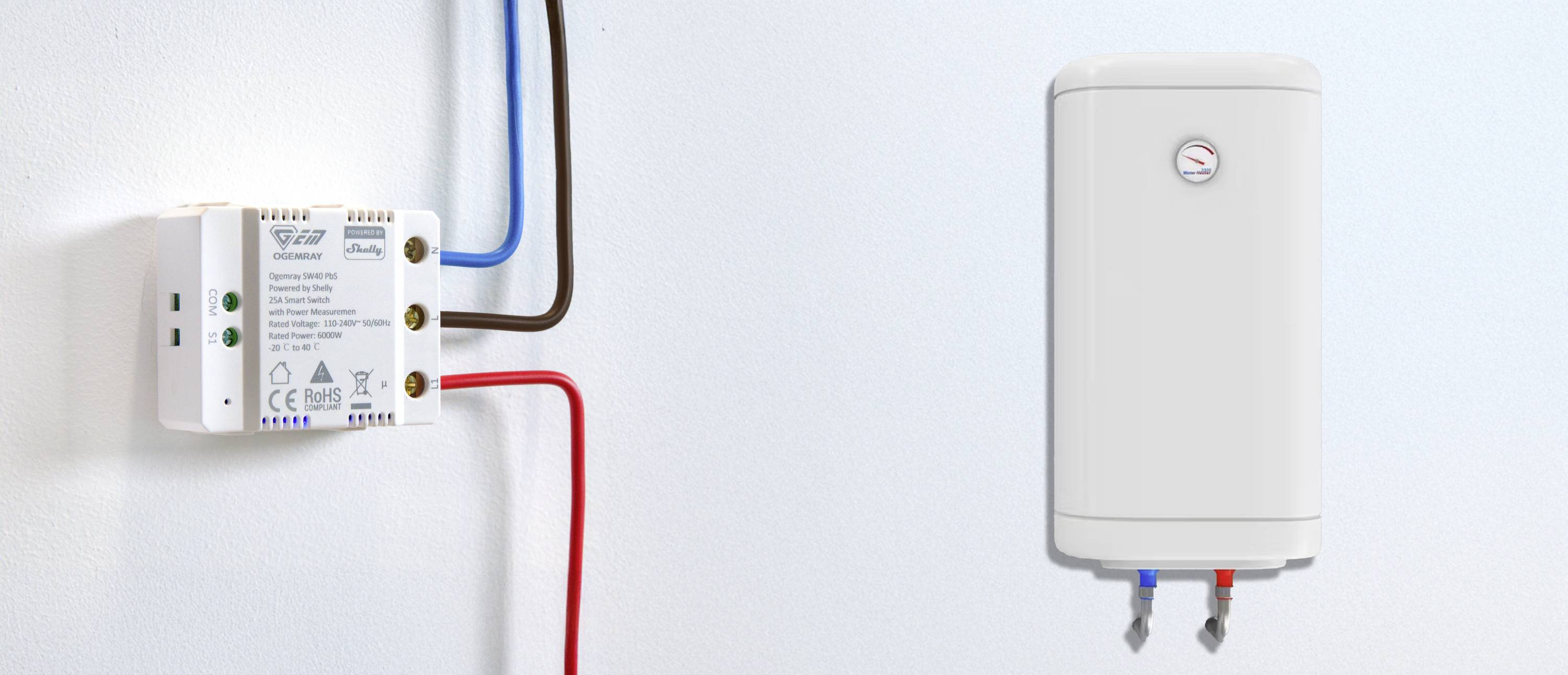 An electric hot water cylinder is mounted on the wall. To the right of it is a control unit with blue and red cables.