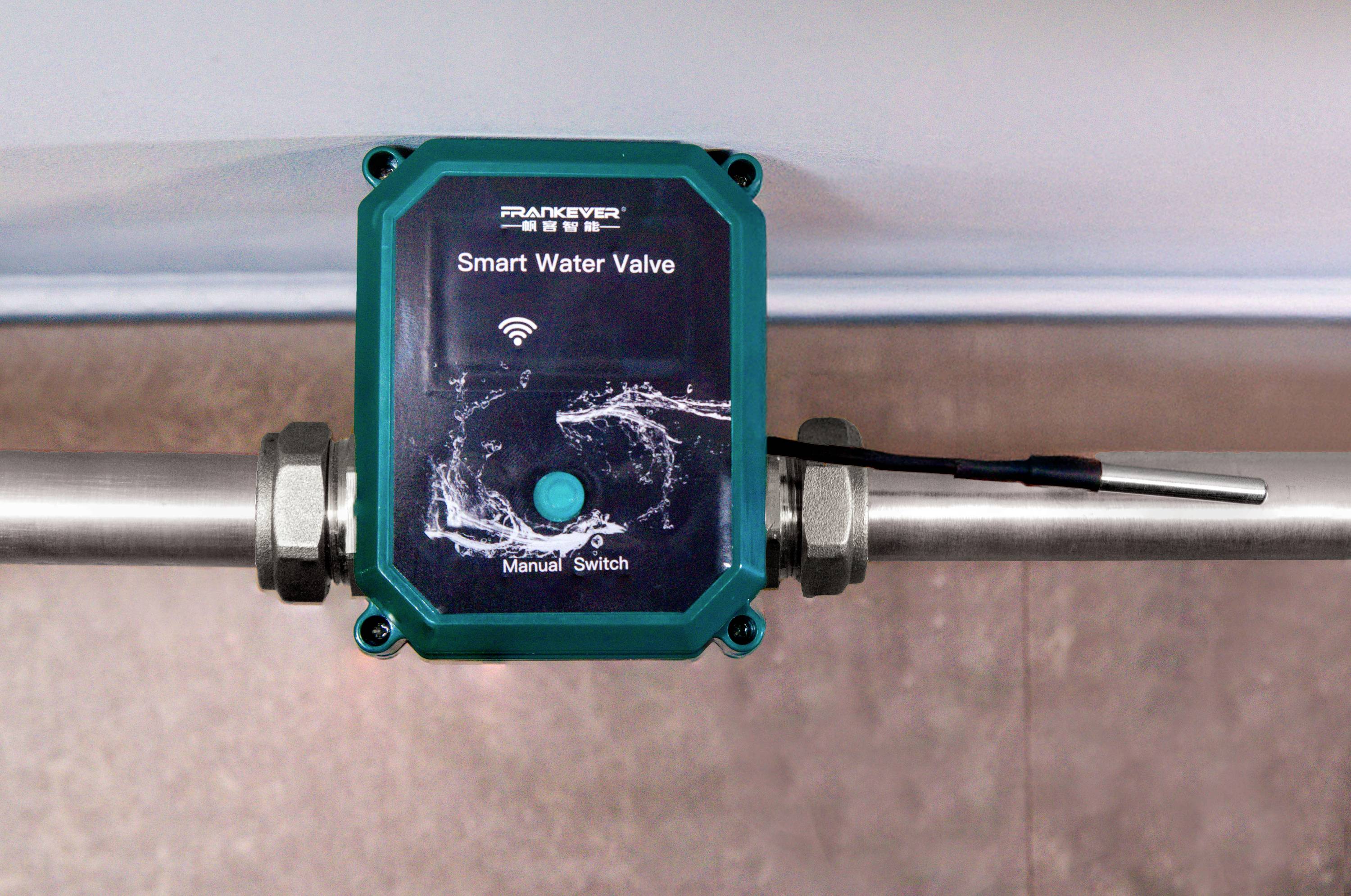 A smart water valve is installed on a pipe. The device has a manual switch and displays a Wi-Fi symbol.