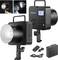 Two studio flashes by Neewer, one with a glowing bulb, the other with a digital display. Accessories such as cables and battery are placed beside them.