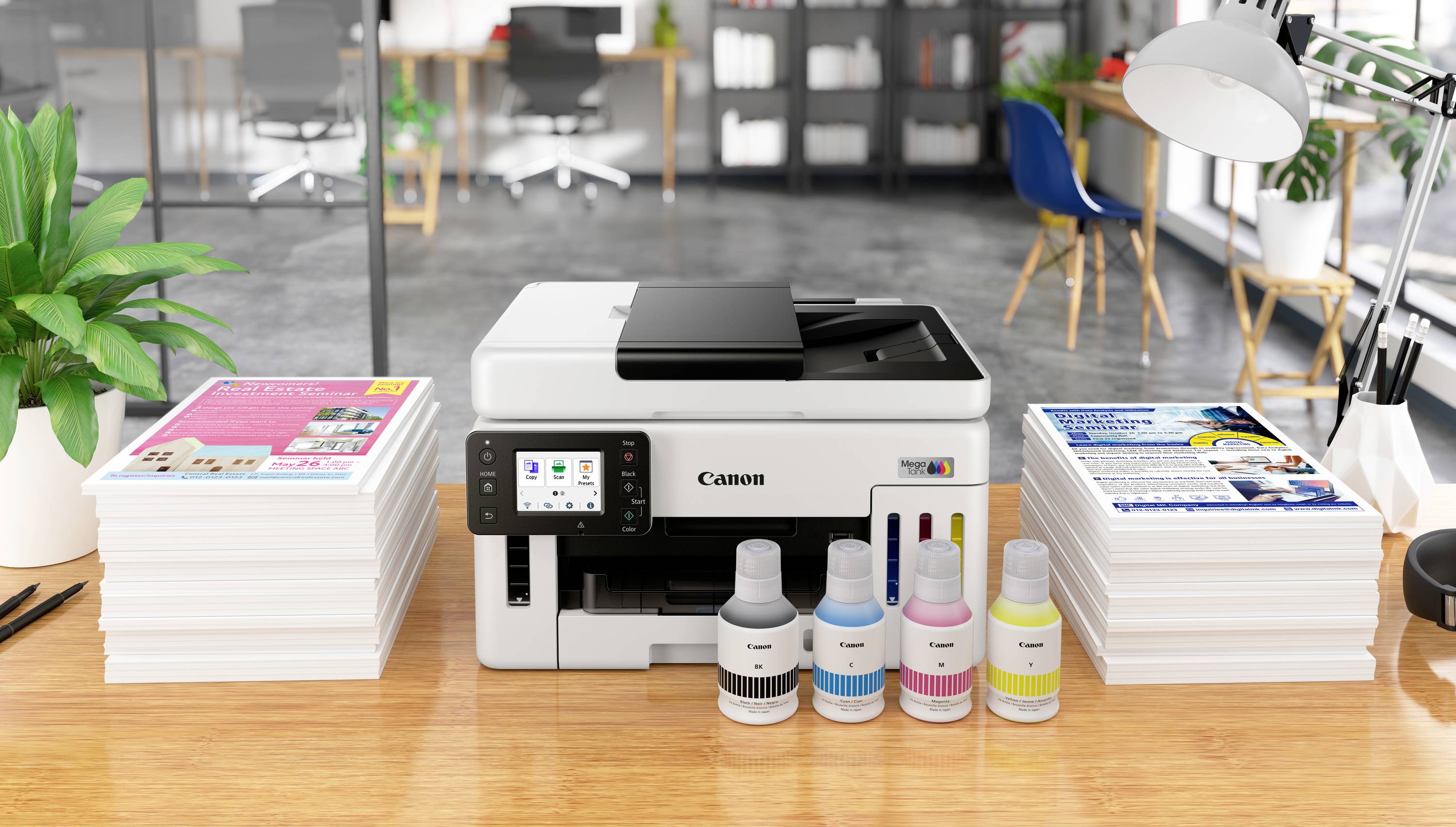 A printer on a desk with two stacks of printed paper and four ink bottles, office background.