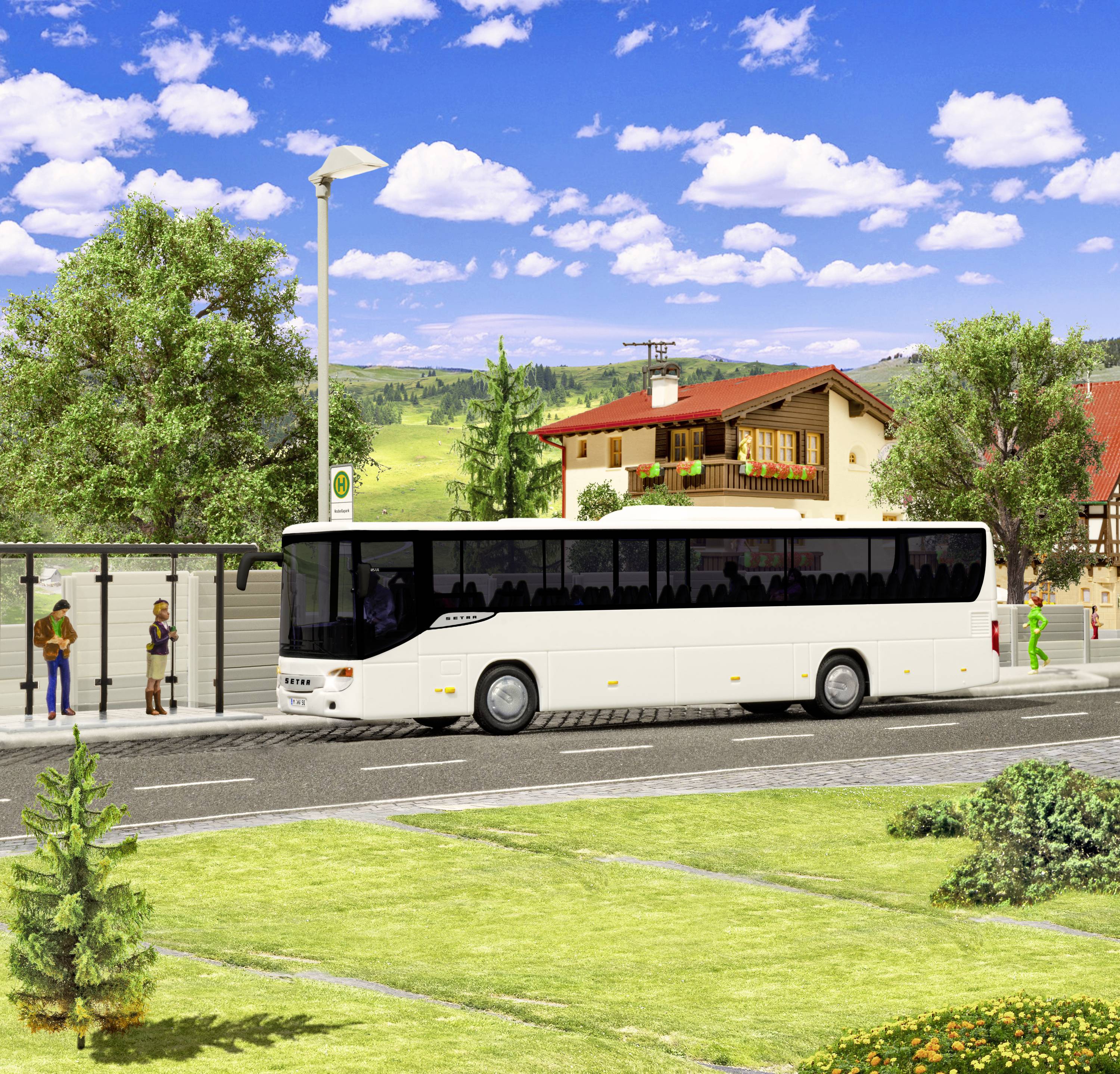 A white bus stops at a rural bus stop with several waiting passengers; houses and trees are visible in the background.
