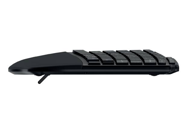 A flat, black computer keyboard shown from the side, with a fold-out stand for height adjustment.