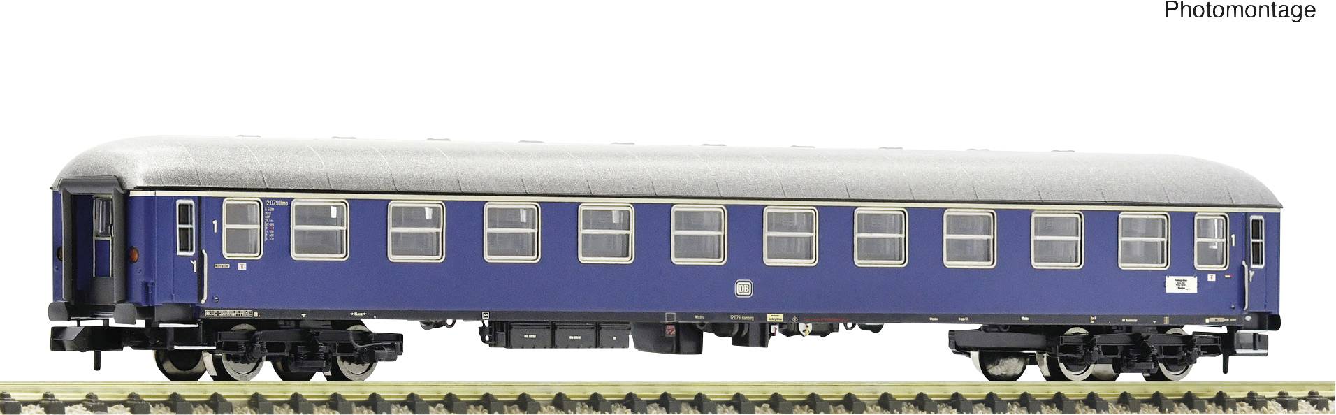A blue model train carriage on a track. The carriage has multiple rectangular windows and a silver roof edge.
