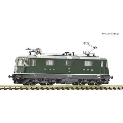The image shows a green model of an SBB FFS electric locomotive on a track, photographed from the side. 'Photomontage' is written in the top right corner.