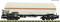 A goods wagon model with a large, white tank and an orange line, standing on railway tracks.