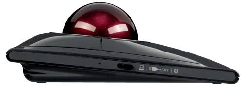 'Black trackball mouse viewed from the side with large red ball and switch on the lower side.'