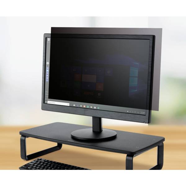 A computer monitor with a privacy filter, which shields the screen from side glances, sits on a desk.