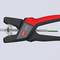 The wire stripper in black and red cuts through a cable. It is a tool used for removing the insulation from cables.