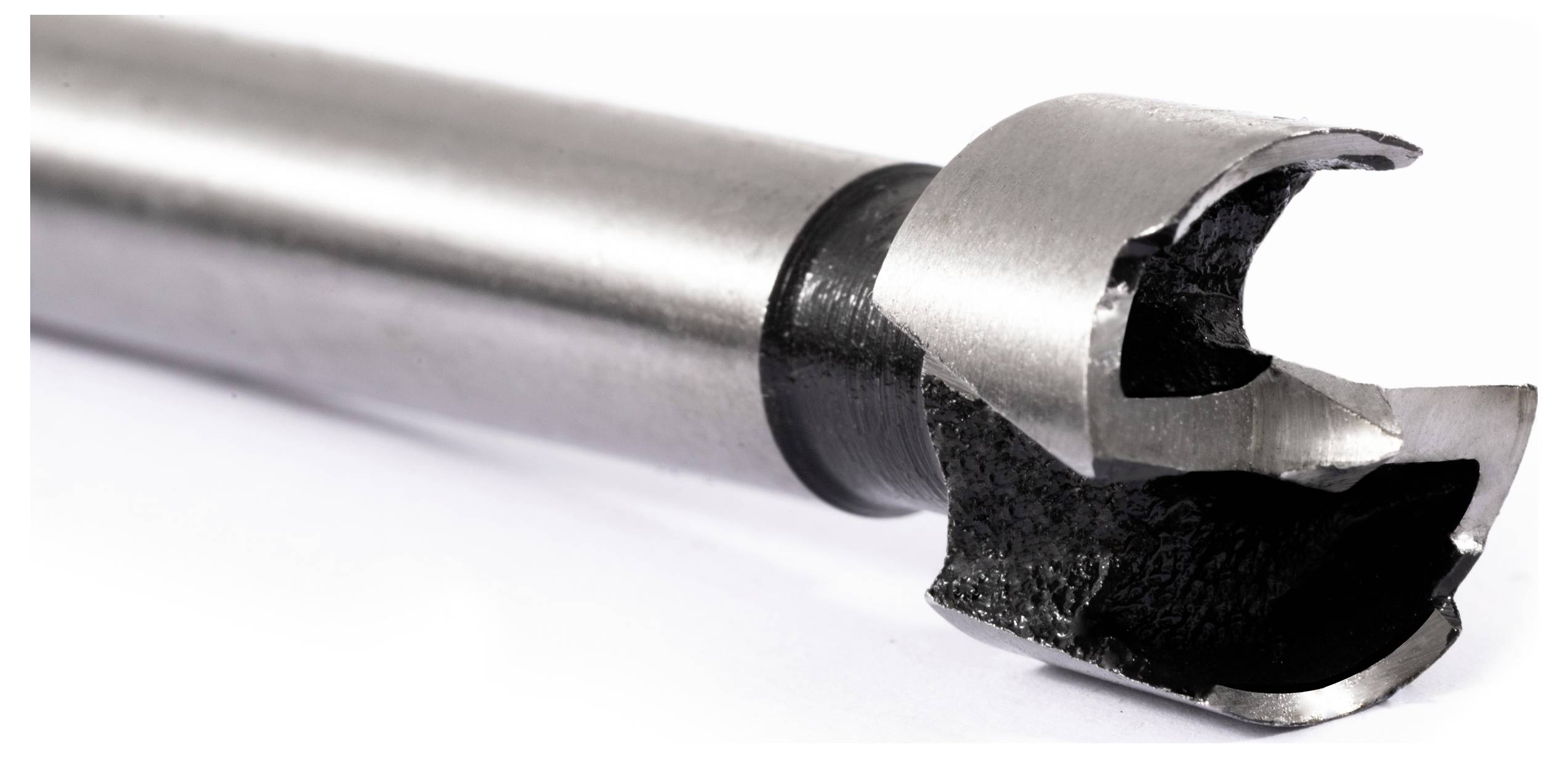 Close-up of a metal hole saw drill bit with sharp teeth, used for cutting holes in materials.