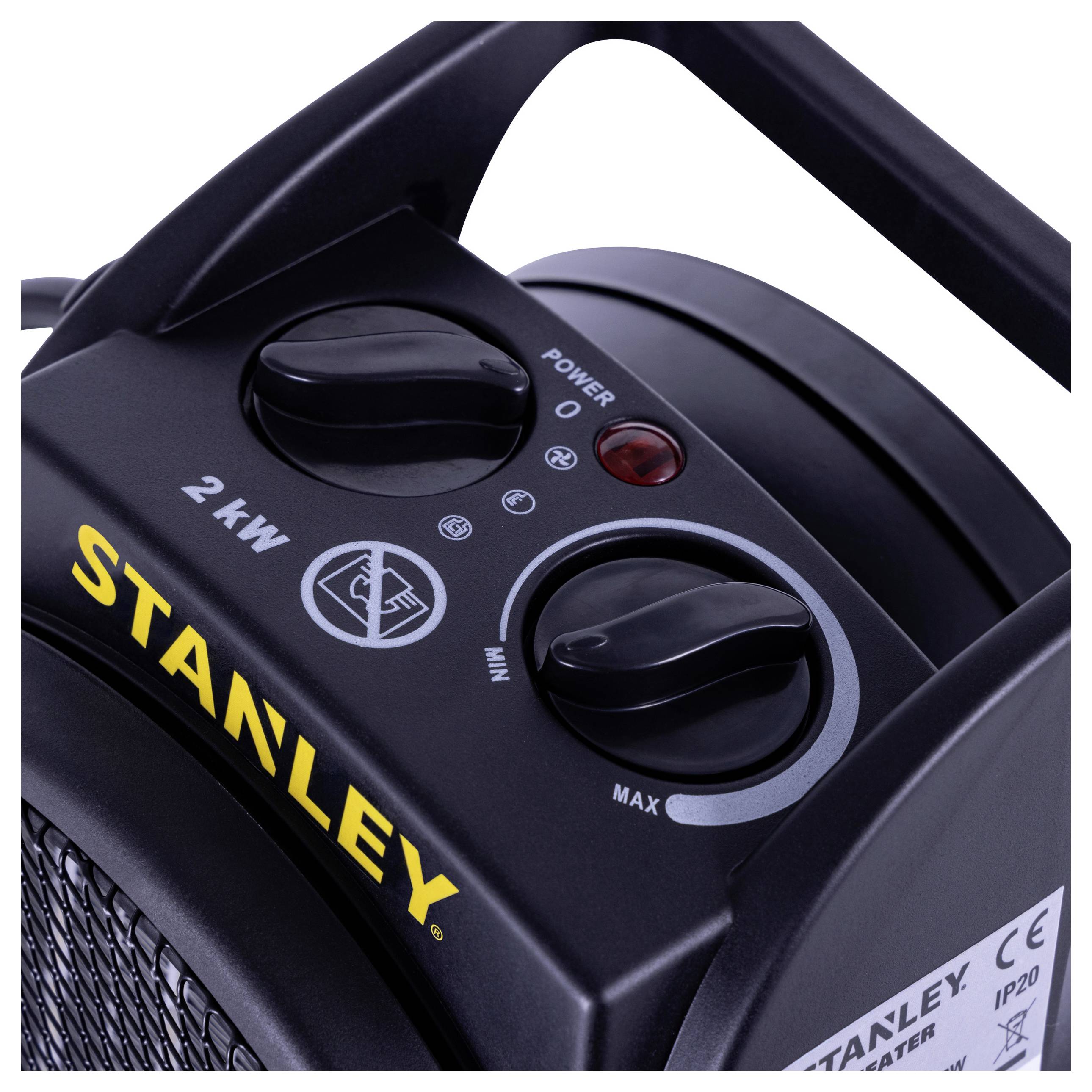 Close-up of a black Stanley portable heater showing power and heat setting dials marked '2 kW', with a red indicator light.