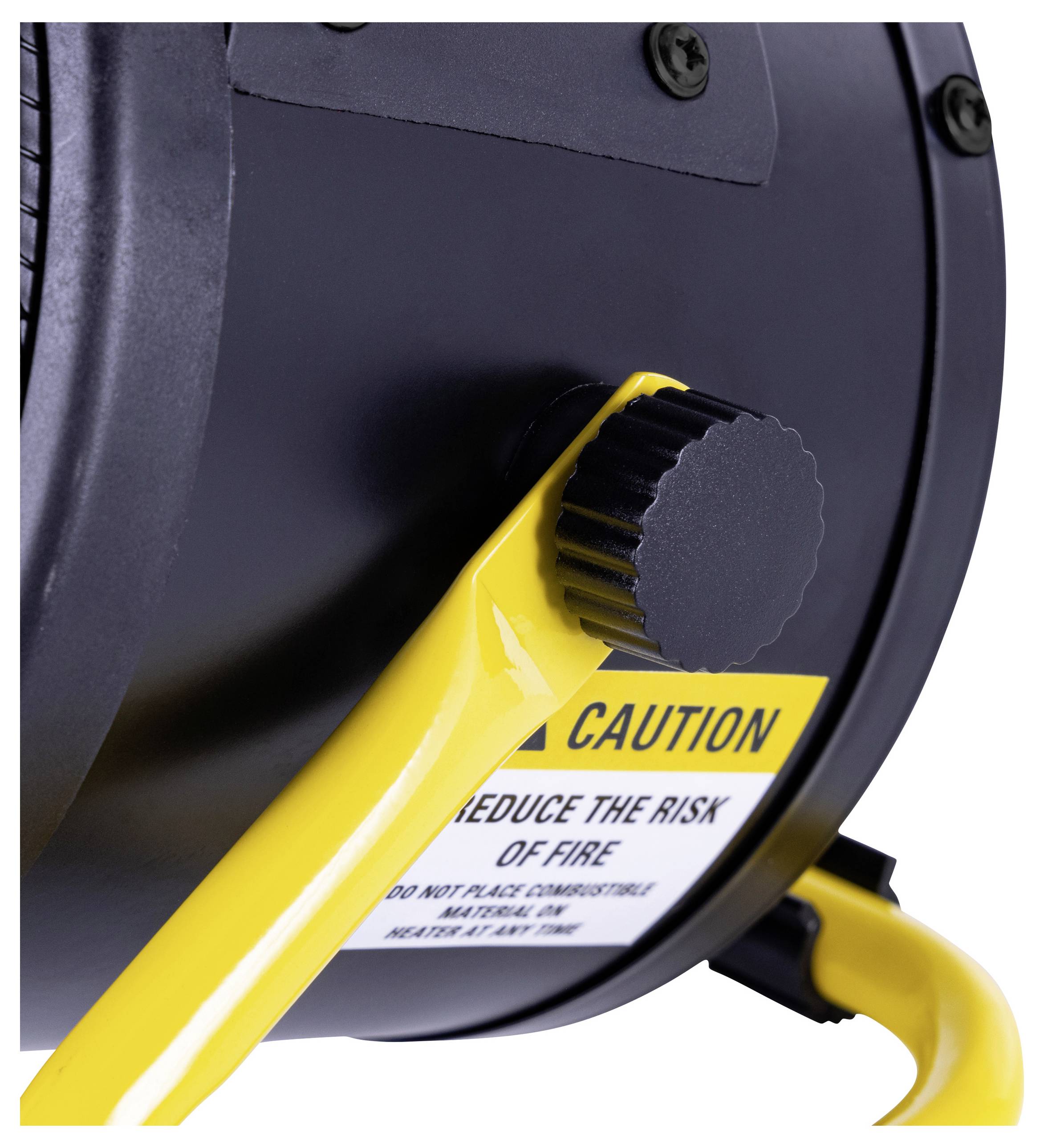 Close-up of a yellow-handle industrial tool with a caution label, warning to 'reduce the risk of fire.'