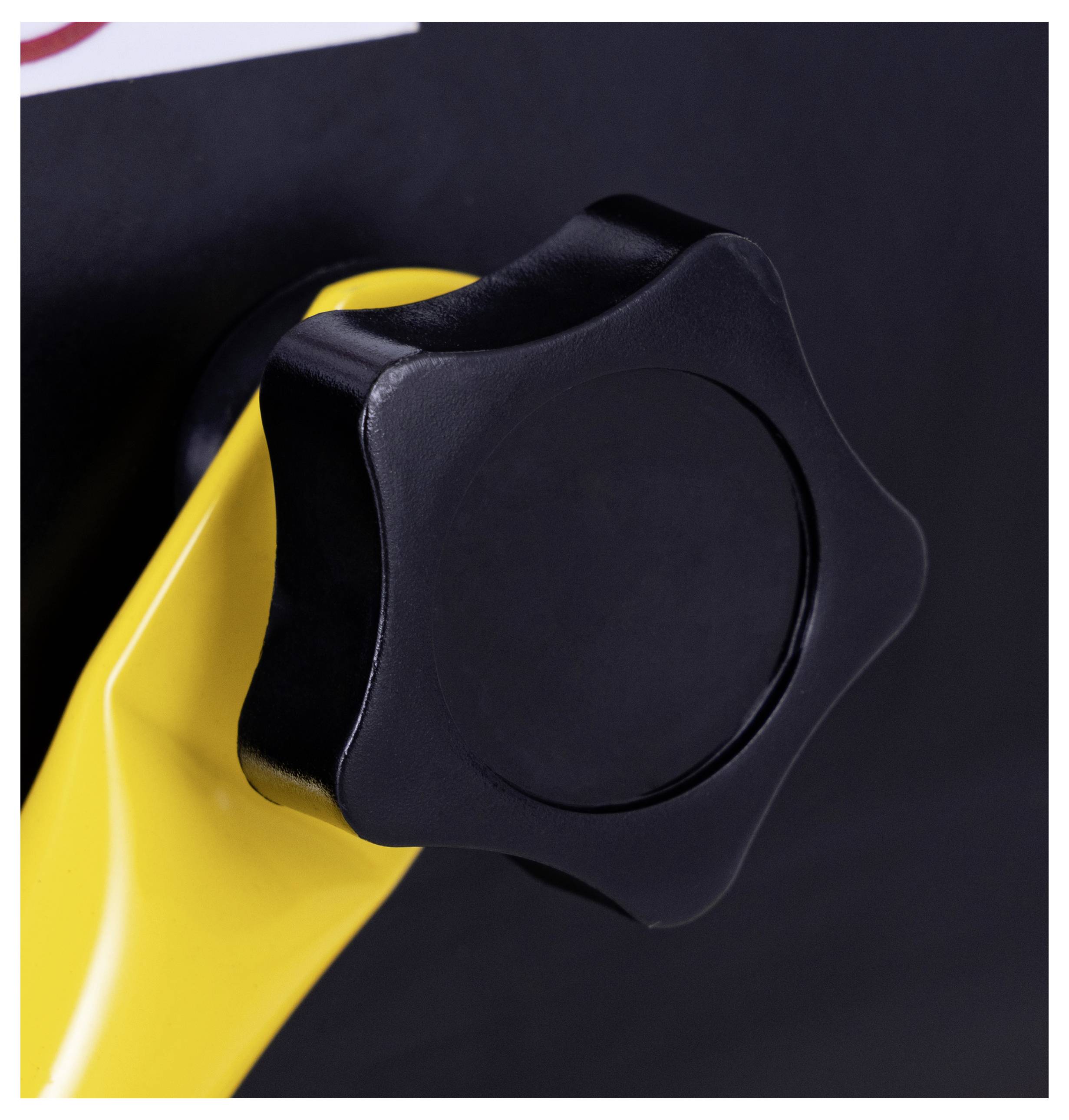 A close-up of a black rotary knob on a yellow lever, set against a dark background. The knob has a circular shape with subtle ridges.
