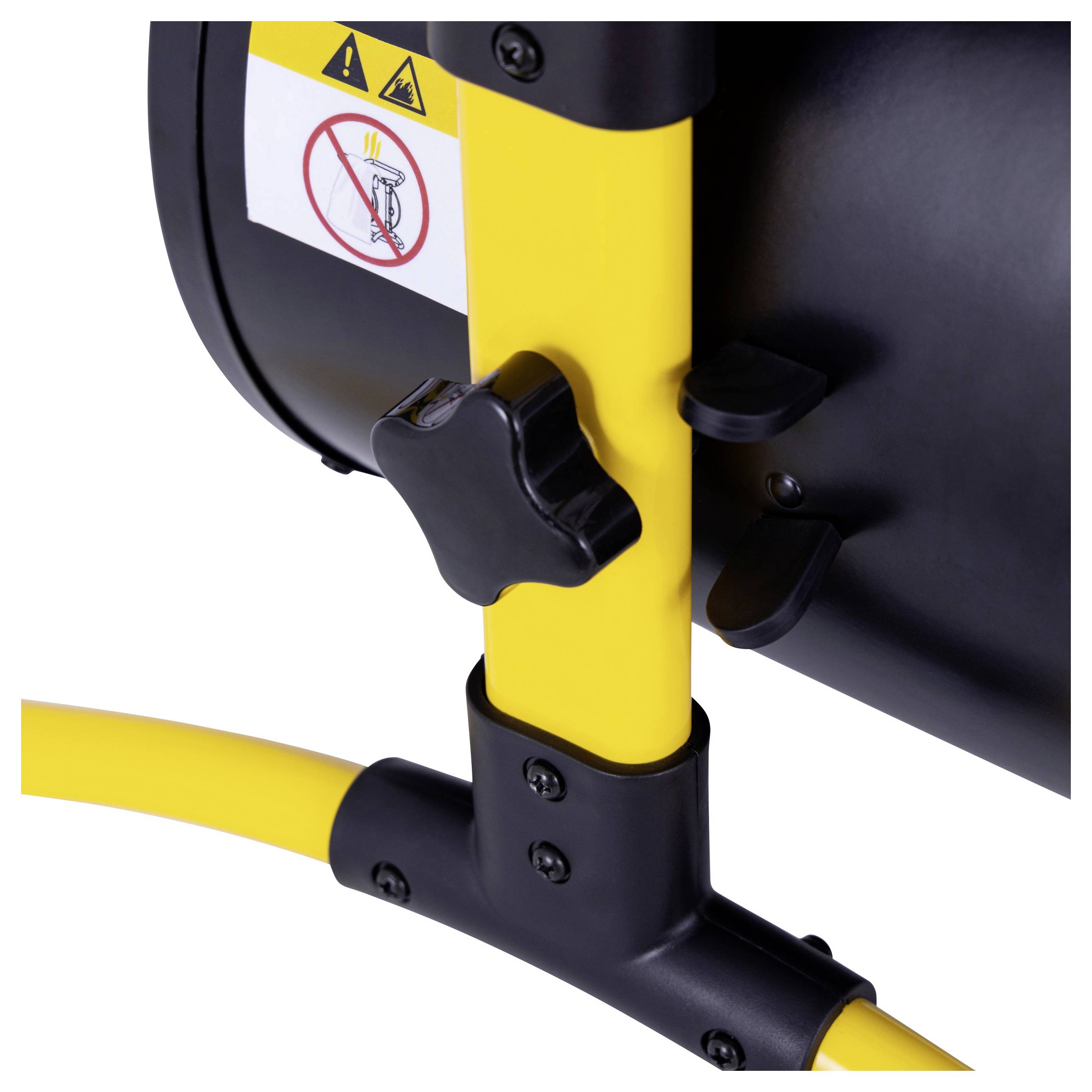 A close-up of a yellow and black heater with a warning label showing 'No hand on heater'. Visible control knob for adjustments.