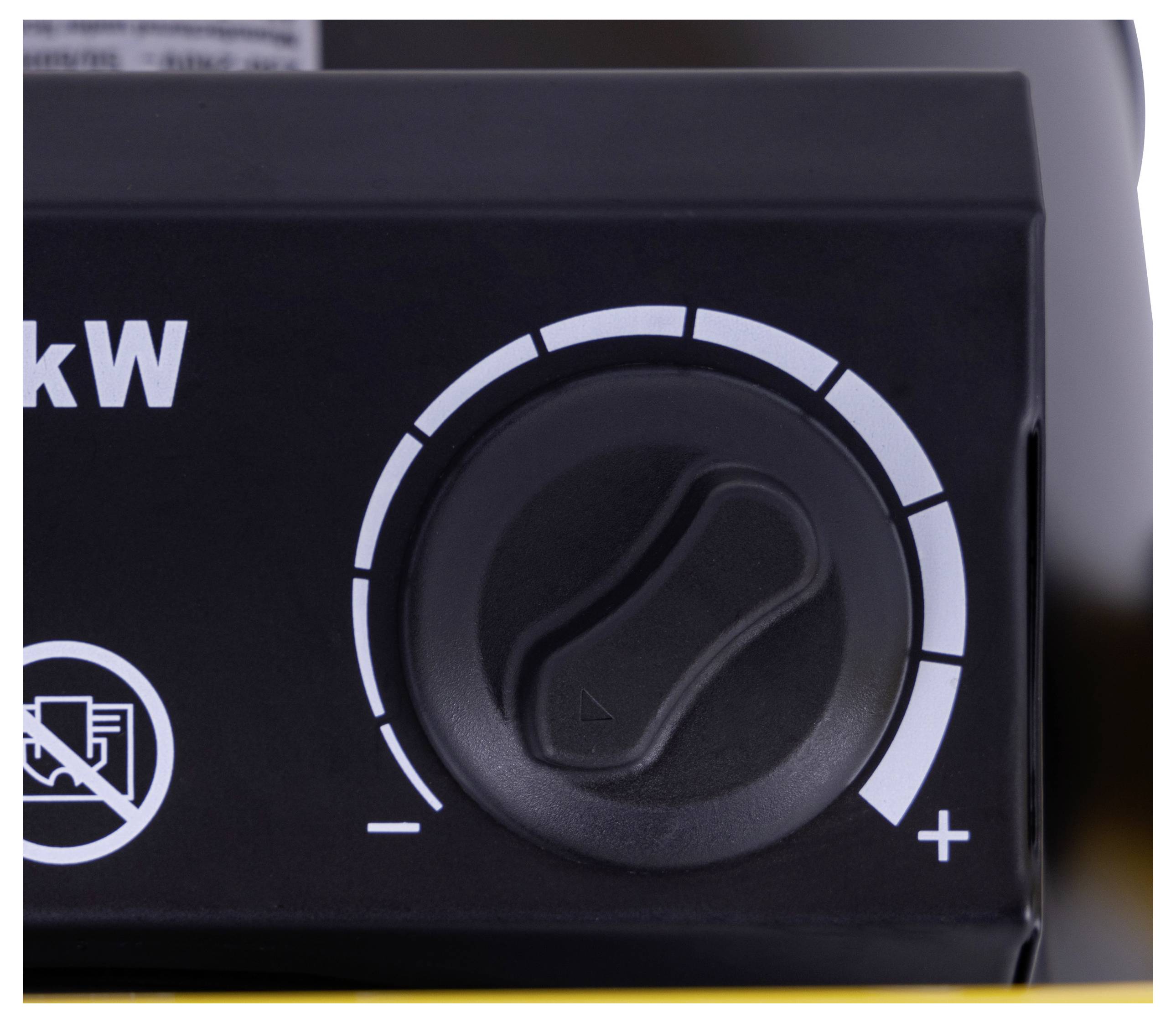 A close-up of a control knob on a device, marked with '+' and '-' signs, indicating adjustable settings, likely for power or volume.