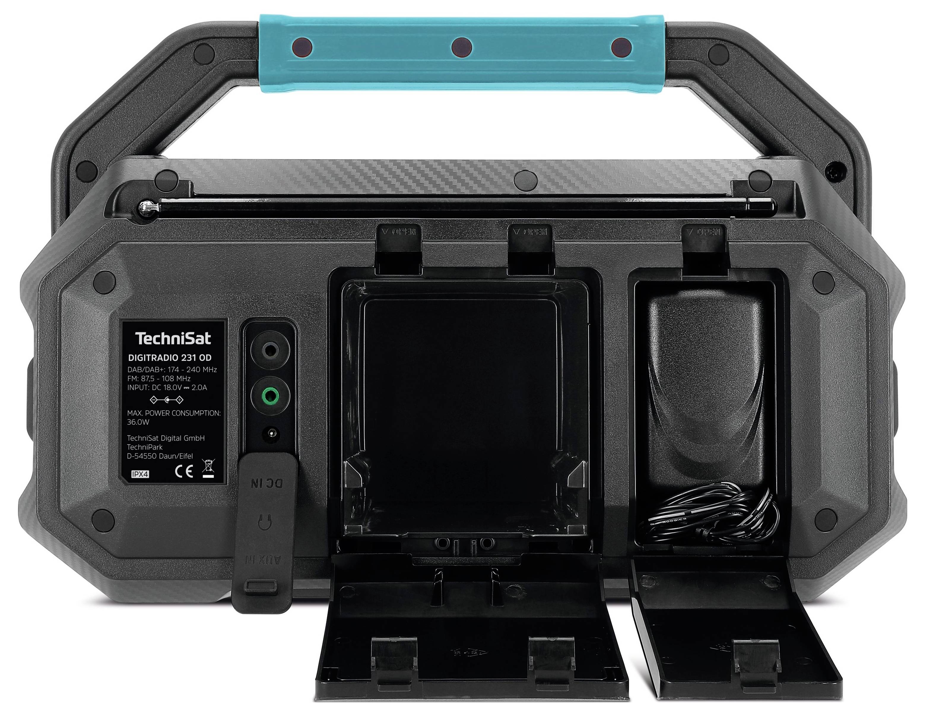Back of a portable radio with battery compartment, sockets, and a compartment for cable storage.