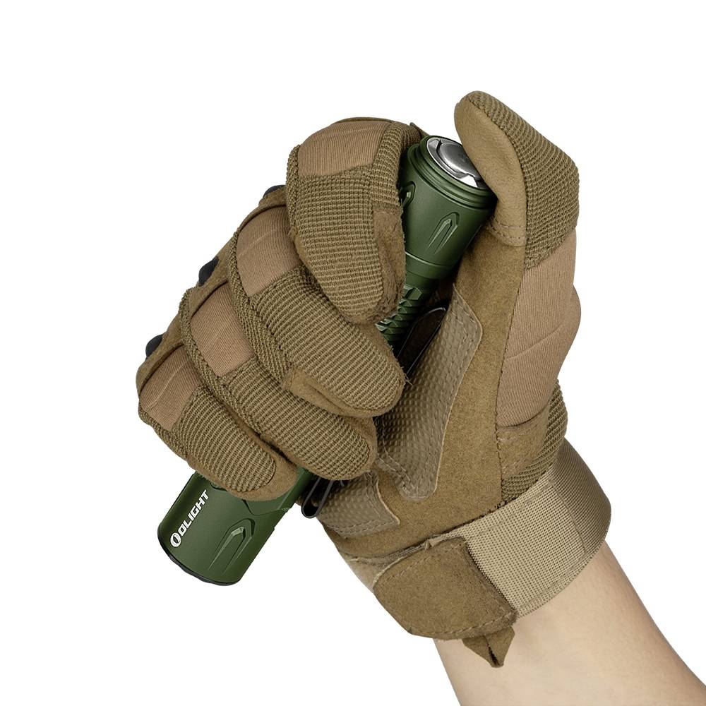 A gloved hand holds a green torch. The person is wearing brown tactical gloves.