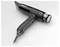 A black Valera hair dryer is lying on a white surface. The hair dryer has several switches on the handle and a cable.