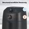 Black hot air fryer with two illuminated buttons for temperature and timer settings on a kitchen table.