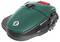 A green, compact lawn mowing robot with large wheels and a black base. It has a red control element on top.