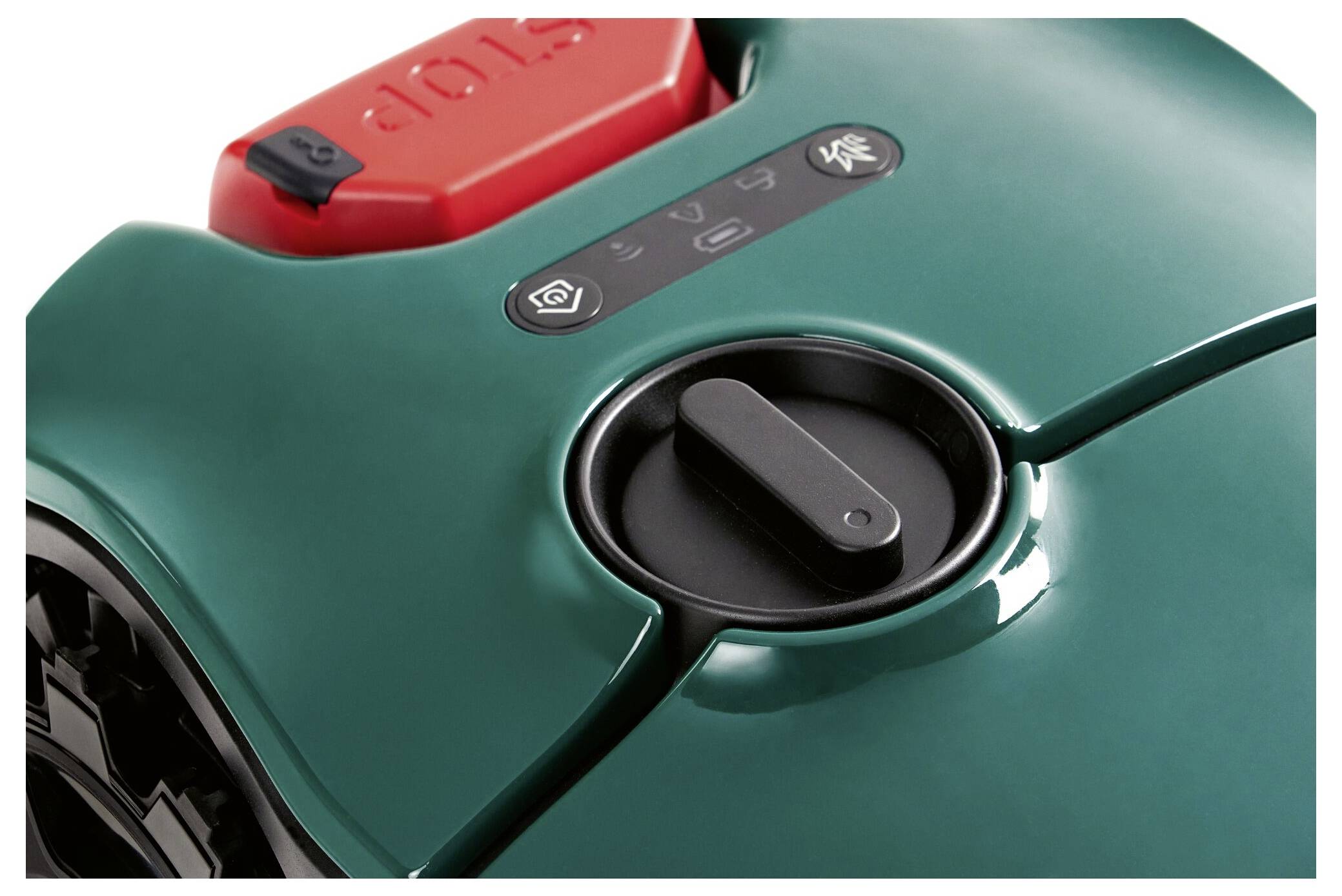 A green automatic lawnmower with a red 'STOP' button. Control panel displays symbols for operation and adjustment.