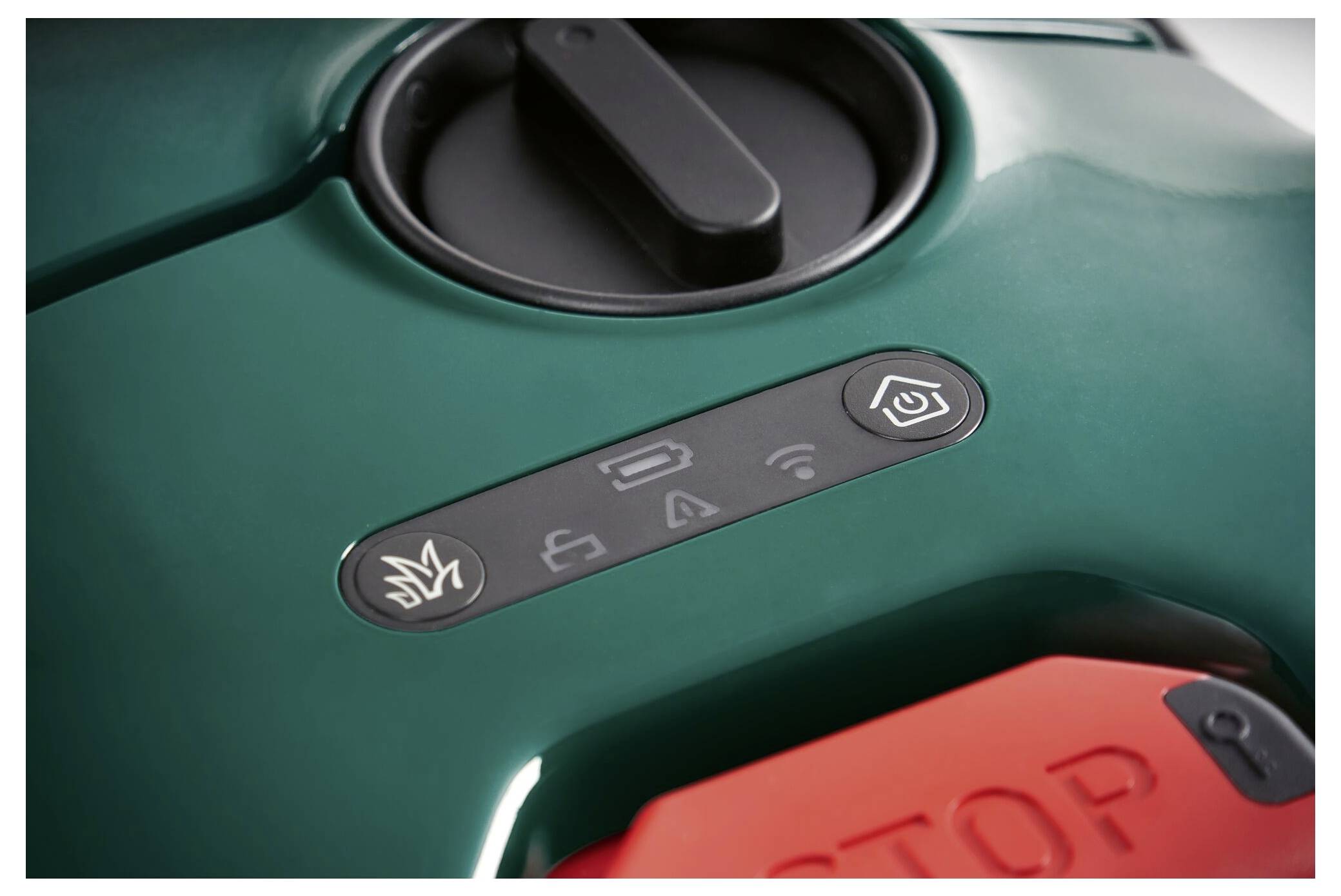 Green robotic lawn mower with a control panel displaying icons for operation, Wi-Fi, and sensor. Red stop button in the foreground.