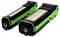 Two green LED torches in black casings, lying side by side.