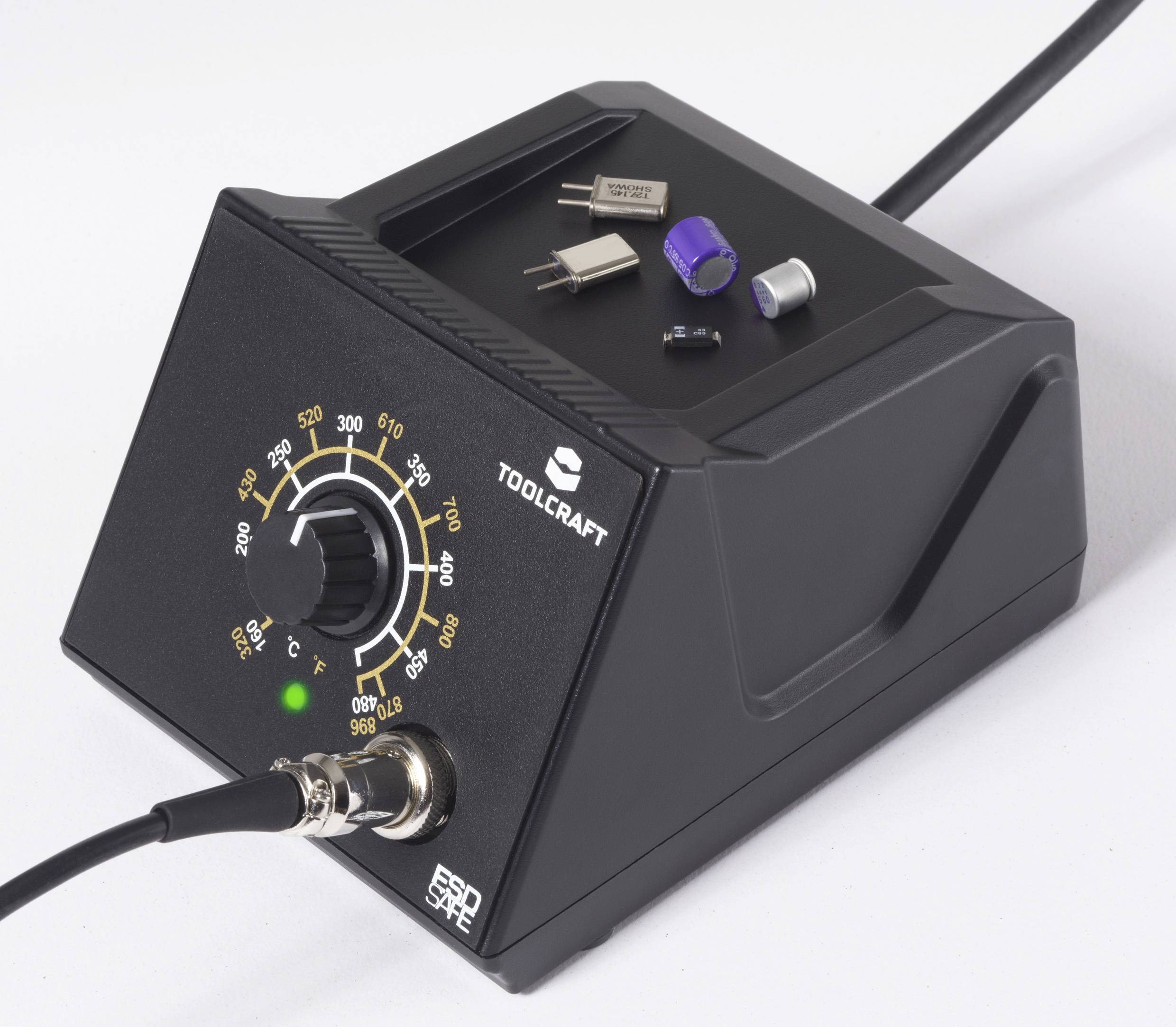 A black soldering station with a dial showing temperature settings from 60°C to 620°C. Small electronic components rest on top.
