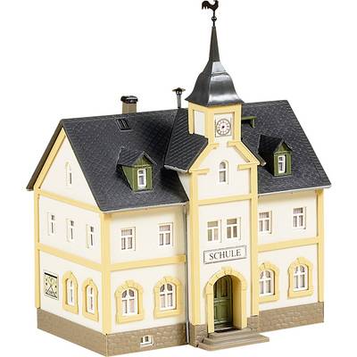 A model of a small building with the inscription 'School' above the door. The building has yellow frames, a pointed roof, and a weathervane.