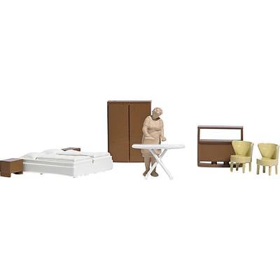 A miniature model shows a bedroom setup with a bed, a standing figure, an ironing board, a wardrobe, and two chairs.