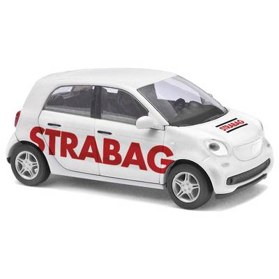 A white toy car with the red STRABAG logo on the side and bonnet. The car is a model of a modern compact car.