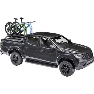 A black pick-up truck with two bicycles on a roof rack. The vehicle has four doors and robust tyres.