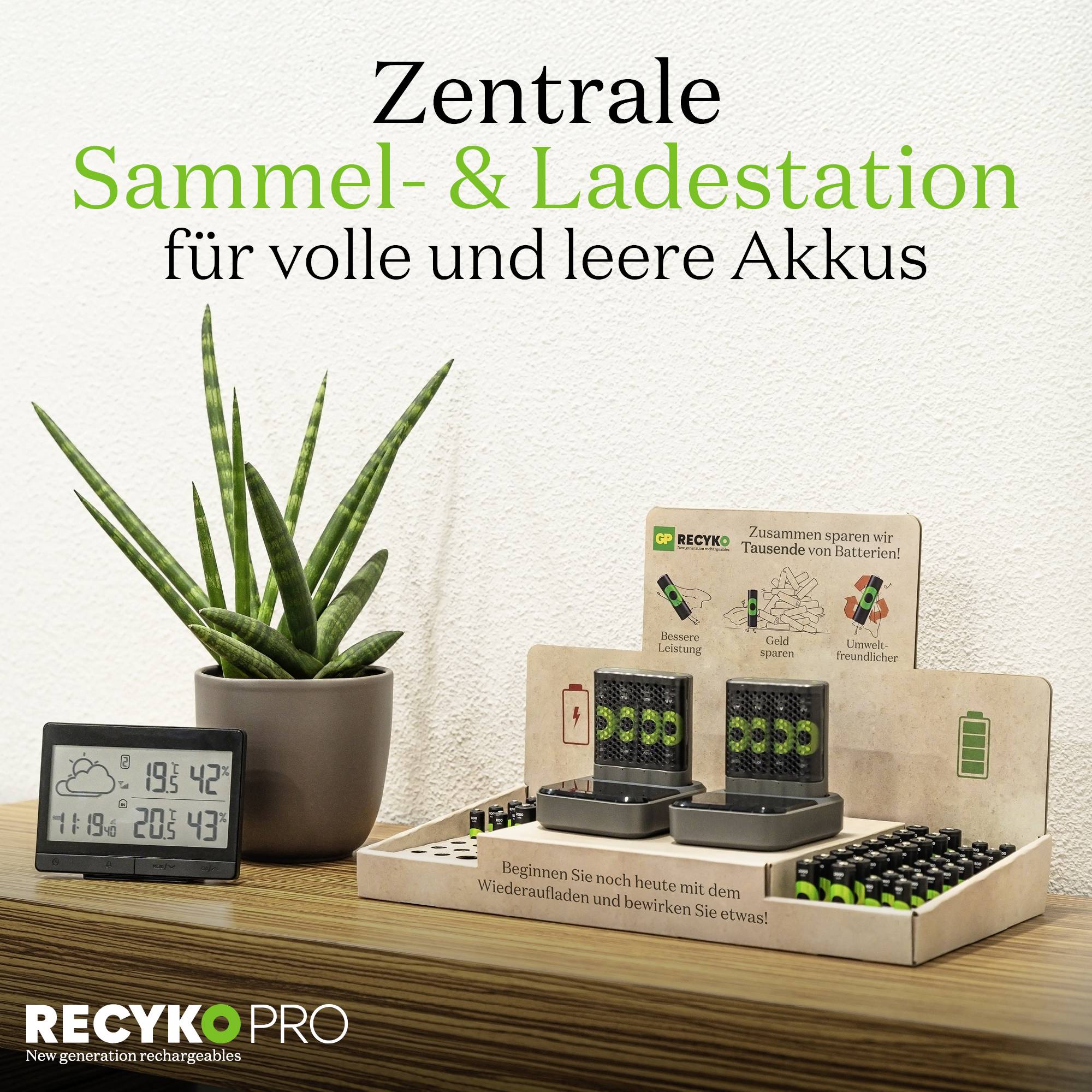 'Central Collection & Charging Station for Full and Empty Batteries', a table display with batteries, chargers, a plant thermometer and a digital thermometer.