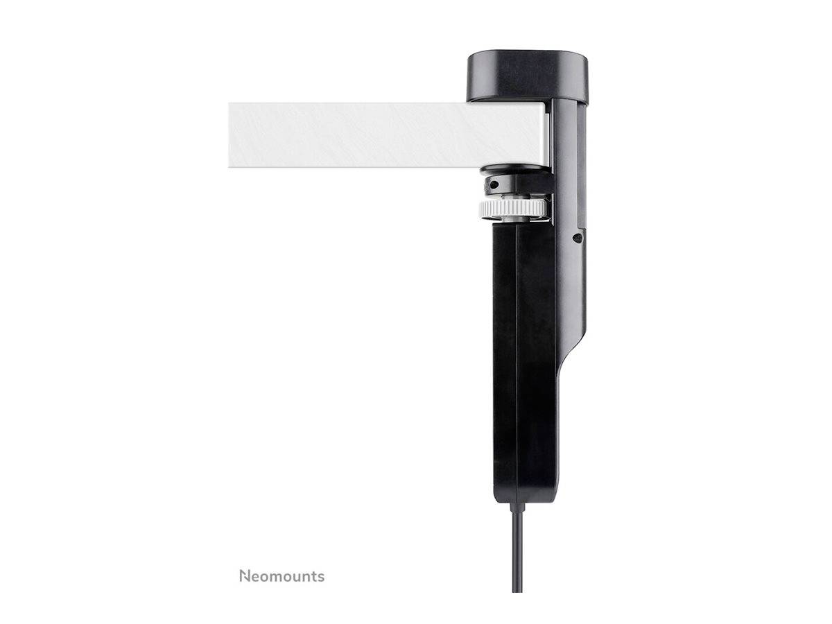 Monitor mount attached sideways to a white desk; black, adjustable design with cable. 'Neomounts' logo in the background.
