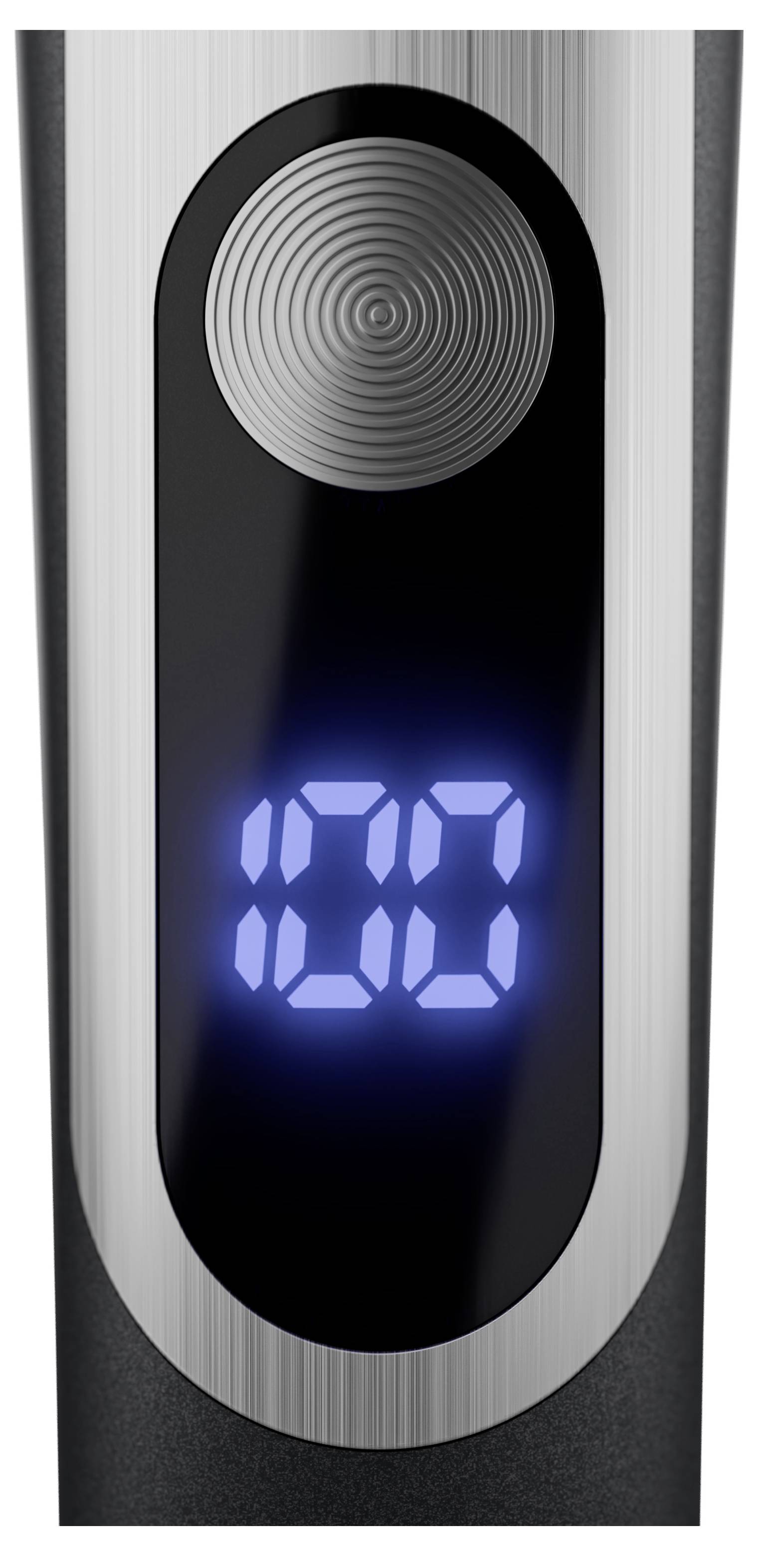 Electronic device with a blue illuminated display. Display shows '100'. A round, textured element is located above the display.