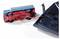 An overturned toy fire engine is connected to a black device. A red cable links the two objects.