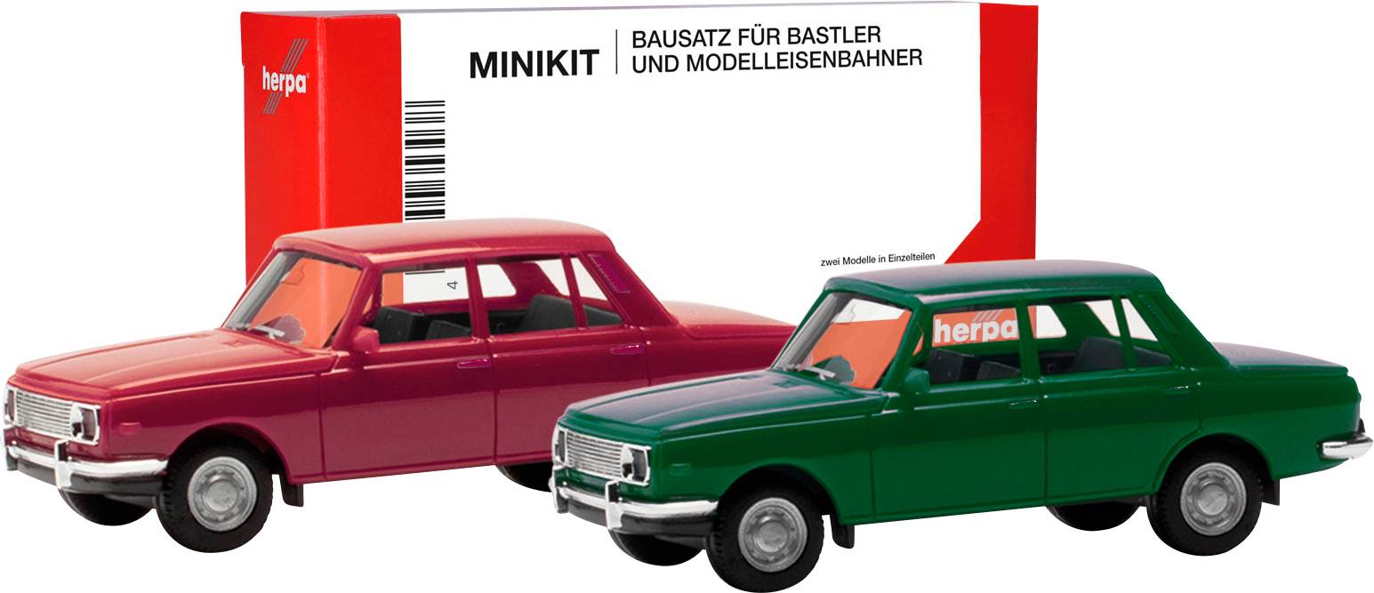 Two model cars, red and green, in front of packaging with the inscription 'Minikit Construction Kit for Hobbyists and Model Railway Enthusiasts'.