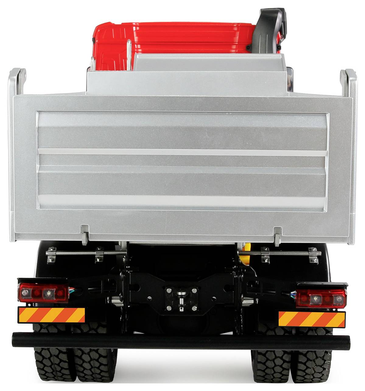 A toy tipper truck with red and silver details, viewed from behind. The loading bed is raised, with robust tyres.