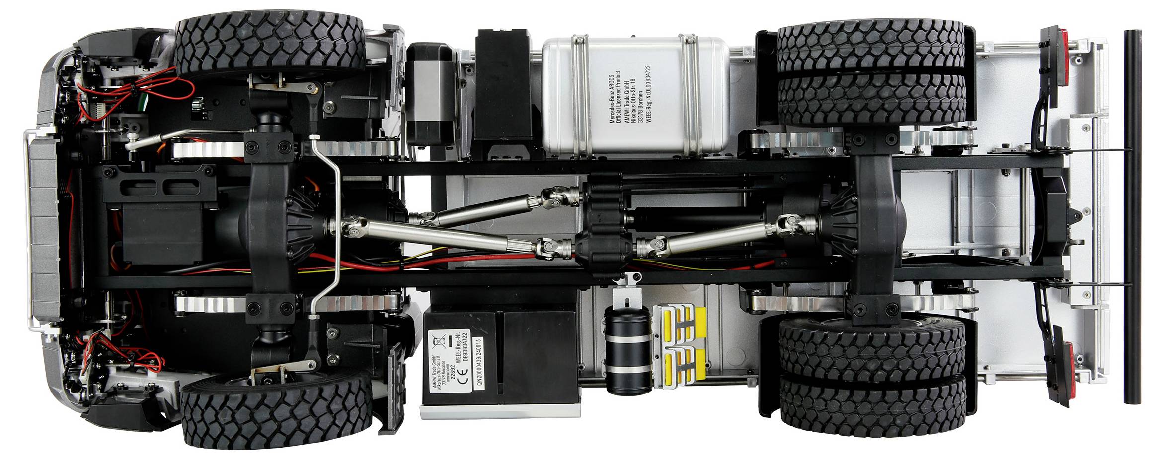 Underside of a model lorry with visible axles, wheels, and cables; showcasing the technical details and structure of the vehicle.