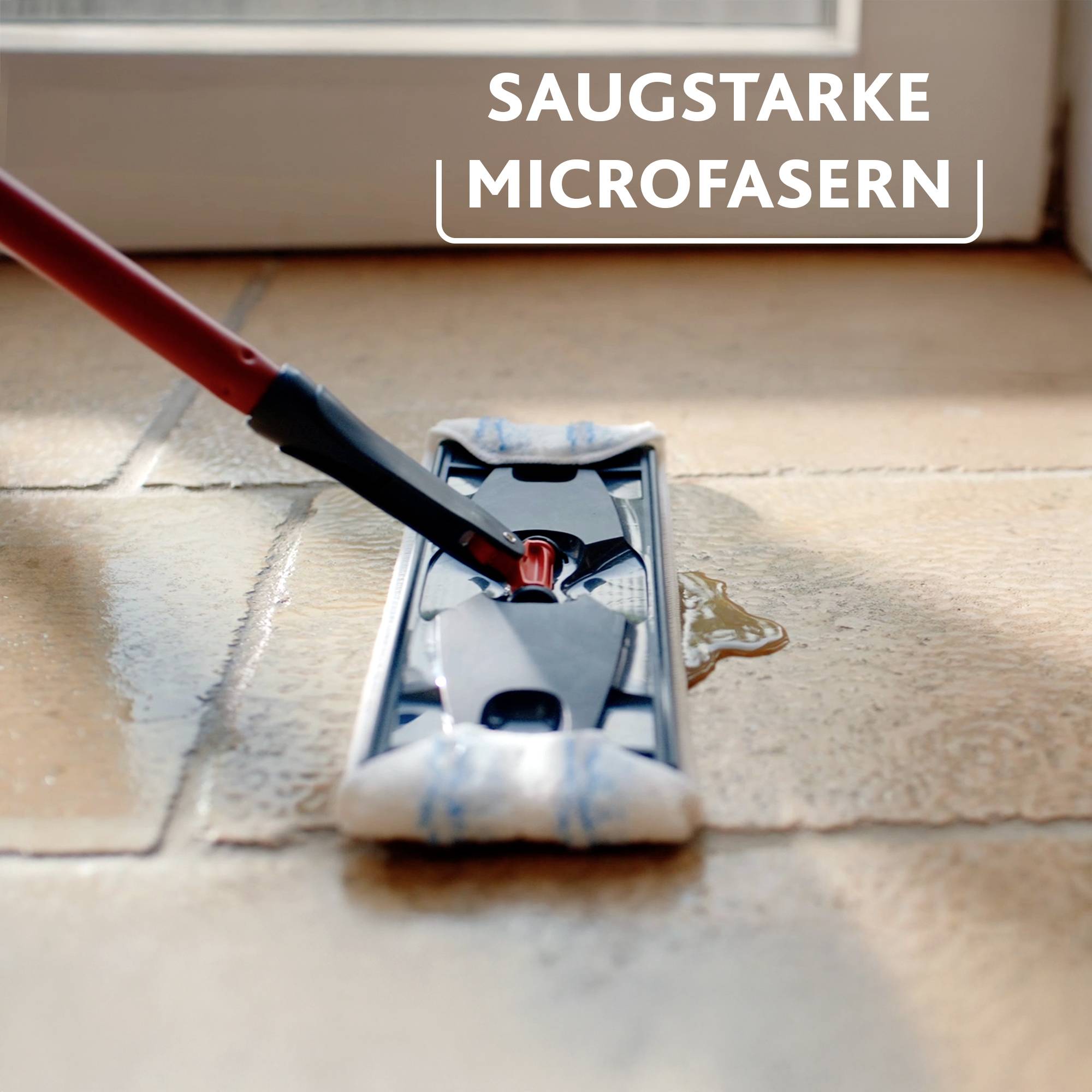 A floor mop with a red handle is cleaning a wet tile. Caption: 'Super-absorbent Microfibre'.