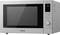 Silver microwave with digital display showing '1:00', function buttons, rotary dial, and ventilation slots on the right side.